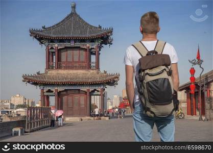 male tourist travels in China. Xian city wall.  