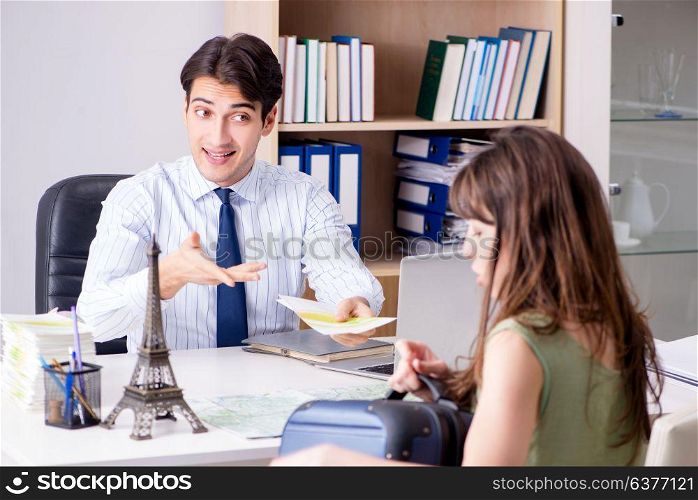 Male travel agent with customer in agency