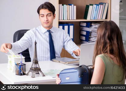 Male travel agent with customer in agency