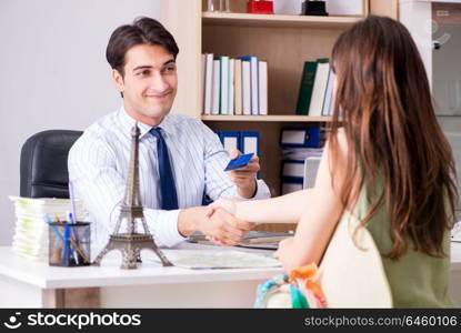 Male travel agent with customer in agency