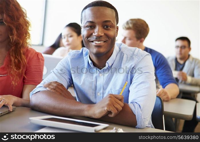 Male University Student Using Digital Tablet In Classroom
