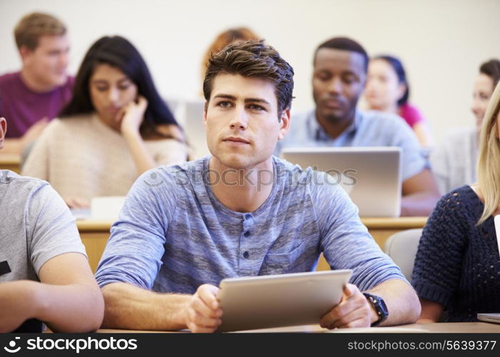 Male University Student Using Digital Tablet In Lecture