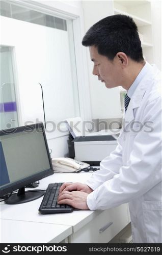 Male veterinarian using computer