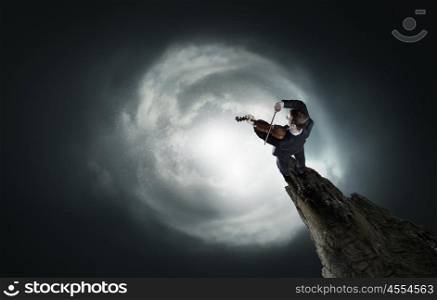Male violinist. Top view of young businessman playing violin