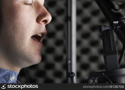 Male Vocalist With Microphone In Recording Studio