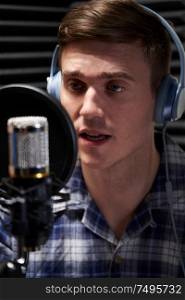 Male Voice Over Artist In Recording Studio Talking Into Microphone