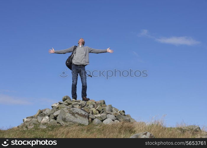 Male Walker Standing On Pile Of Rocks