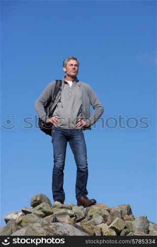 Male Walker Standing On Pile Of Rocks
