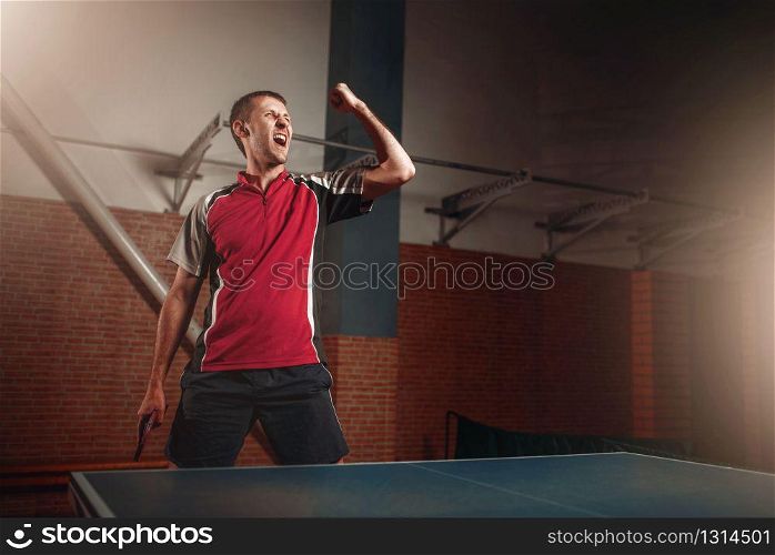 Male winner with racket, table tennis. Ping pong championship, high concentration sport