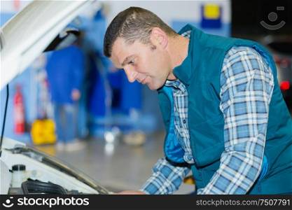male worker checking the engine