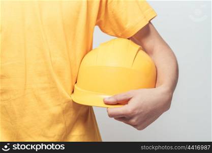 Male worker holding yellow helmet