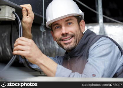 male worker installing mounting clips in a concrete ceiling