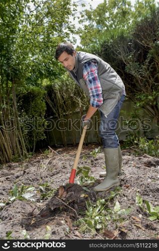 male worker is digging a hole