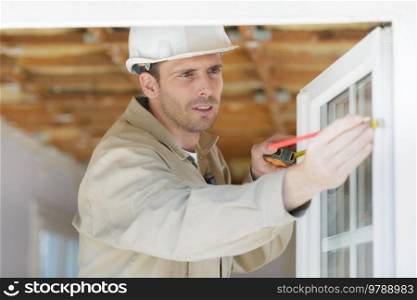 male worker measuring upvc window