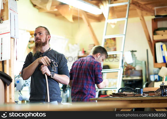 Male workers in leather workshop