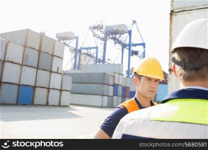 Male workers standing in shipping yard