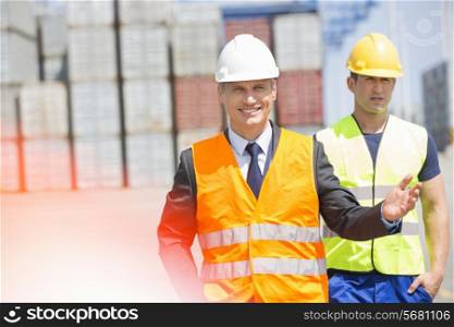 Male workers walking in shipping yard