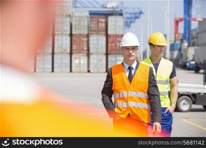Male workers walking in shipping yard