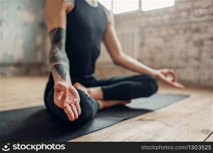 Male yoga, meditation in asana position, full relaxation. Fit workout indoors, yogi studio. Male yoga, meditation in asana position