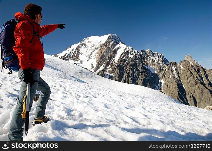 Male young climber standing in front of south side of Mont Blanc; Italy - France