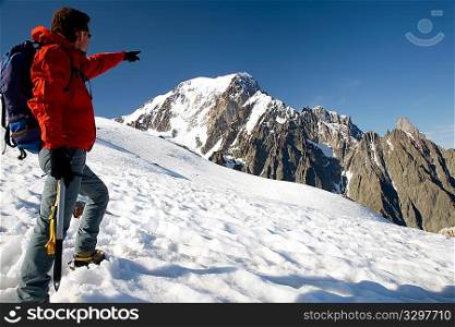 Male young climber standing in front of south side of Mont Blanc; Italy - France