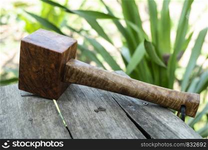 Mallet hammer made of burl wood tools for used by carpenter in workshop on isolated blurred blackground