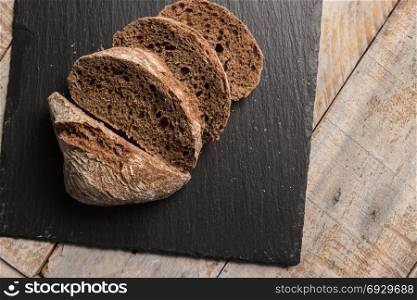Malt loaf bread slices on table.
