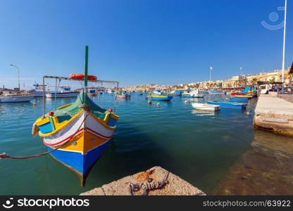 Malta. Marsaxlokk. Traditional fishing boats.. Traditional multicolored fishing boats Luzzi in the harbor Marsaxlokk. Malta.