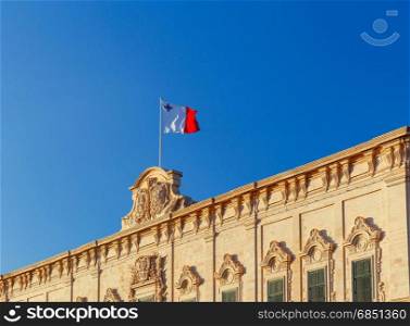 Malta. National Flag.. National flag of Malta against the blue sky in Valletta.