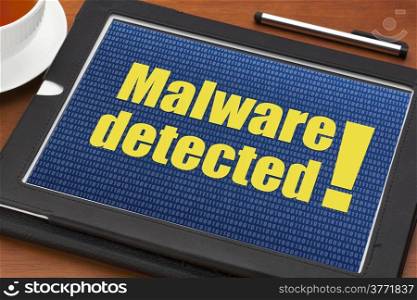 malware detected alert on a digital tablet with a cup of tea