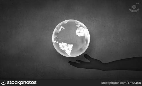 Man&#39;s hand holding digital Earth planet representing global technologies concept