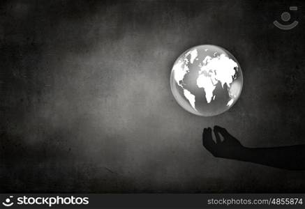 Man&#39;s hand holding digital Earth planet representing global technologies concept