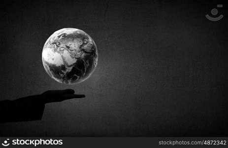 Man&#39;s hand holding digital Earth planet representing global technologies concept