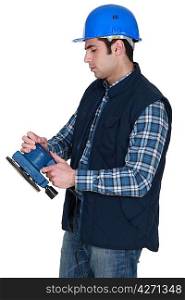 Man about to use electric sander