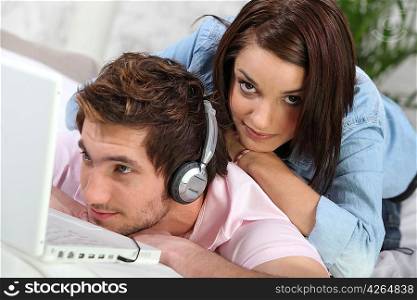 Man absorbed by his music and ignoring his girlfriend