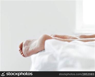 Man&acute;s Feet on Bed