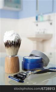 Man&acute;s shaving kit in bathroom