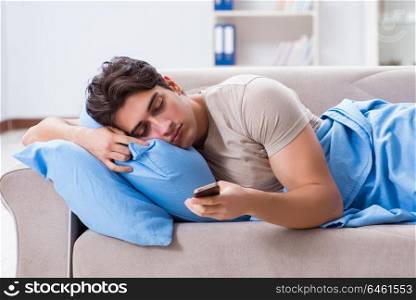 Man addicted to his mobile phone in bed