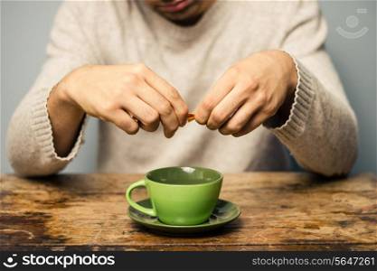Man adding sugar to his coffee