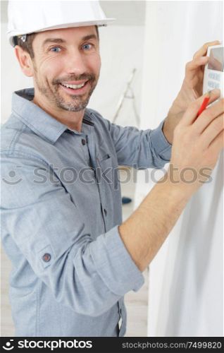 man adjusting air conditioning system