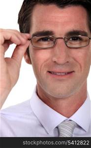 Man adjusting his glasses