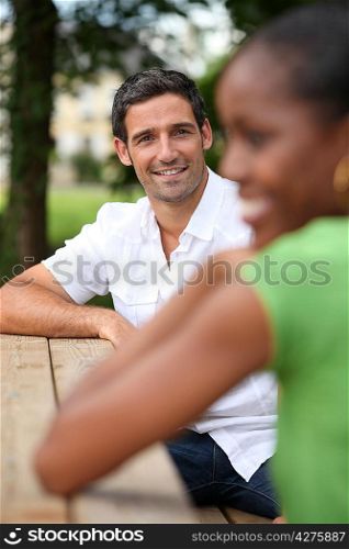 Man admiring an attractive woman in a park