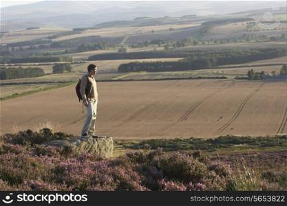 Man Admiring View On Countryside Walk