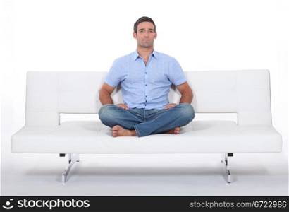 man alone on white sofa