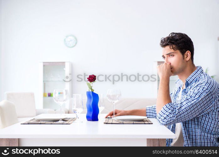 Man alone preparing for romantic date with his sweetheart