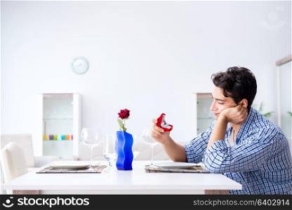 Man alone preparing for romantic date with his sweetheart