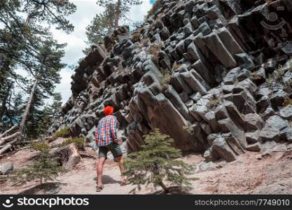 Man amazed by the Devil’s Postpile, Eastern Sierra Nevada, California, USA 