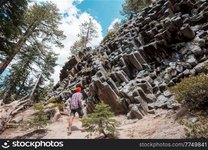 Man amazed by the Devil’s Postpile, Eastern Sierra Nevada, California, USA