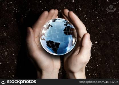 Man&amp;#39;s hand holding digital Earth planet representing global technologies concept