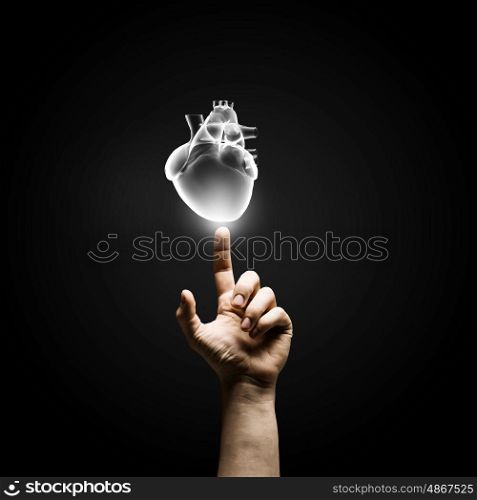 Man&amp;#39;s hand pressing heart icon button on digital touch screen
